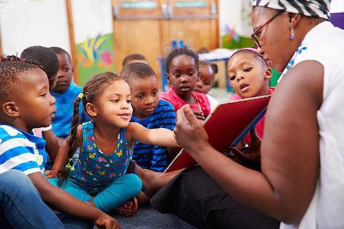 image of teacher reading to preschool children